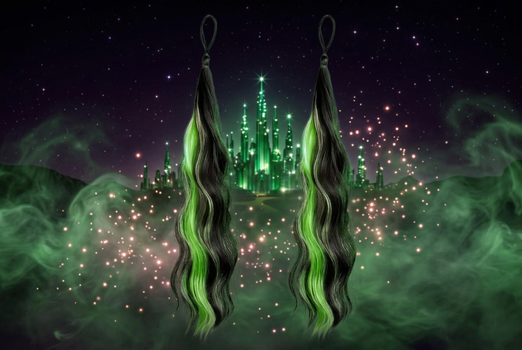 Black and green wavy ponytail extensions in front of a glowing emerald city with green mist and sparkles