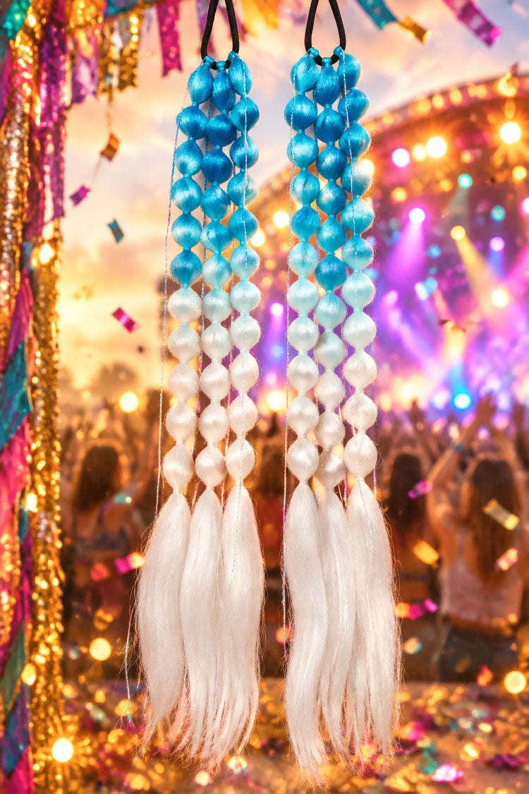 Two blue and white beaded hair extensions on a pink background