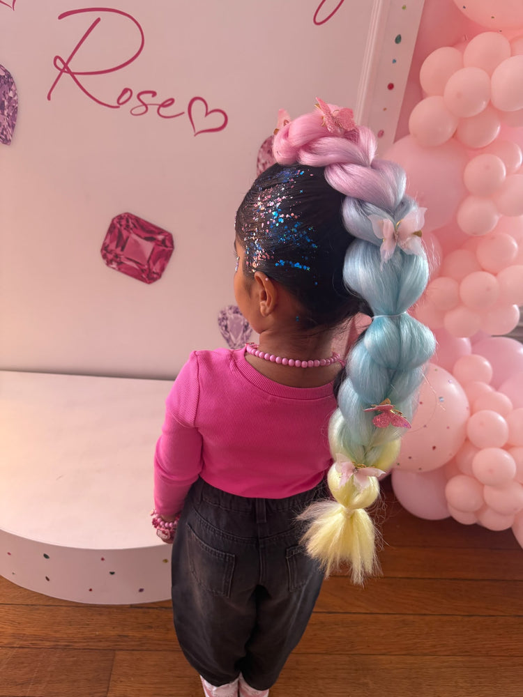 Pastel bubble braid with butterfly clips and glitter roots in front of the Rose backdrop