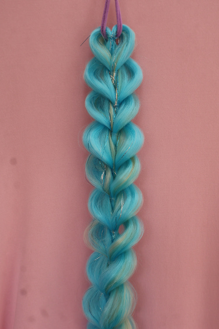 Braided blue hair extensions on a pink background