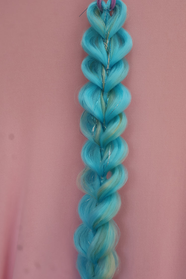 Turquoise braided hair extension on a pink background
