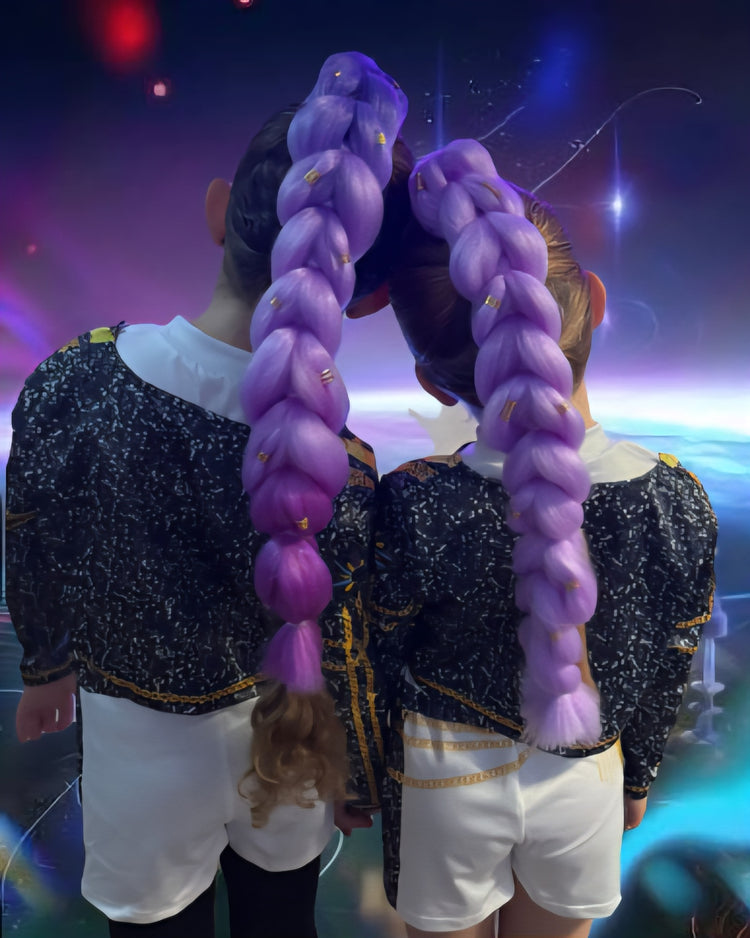 Two people with long purple braids standing back-to-back against a colorful, abstract background.